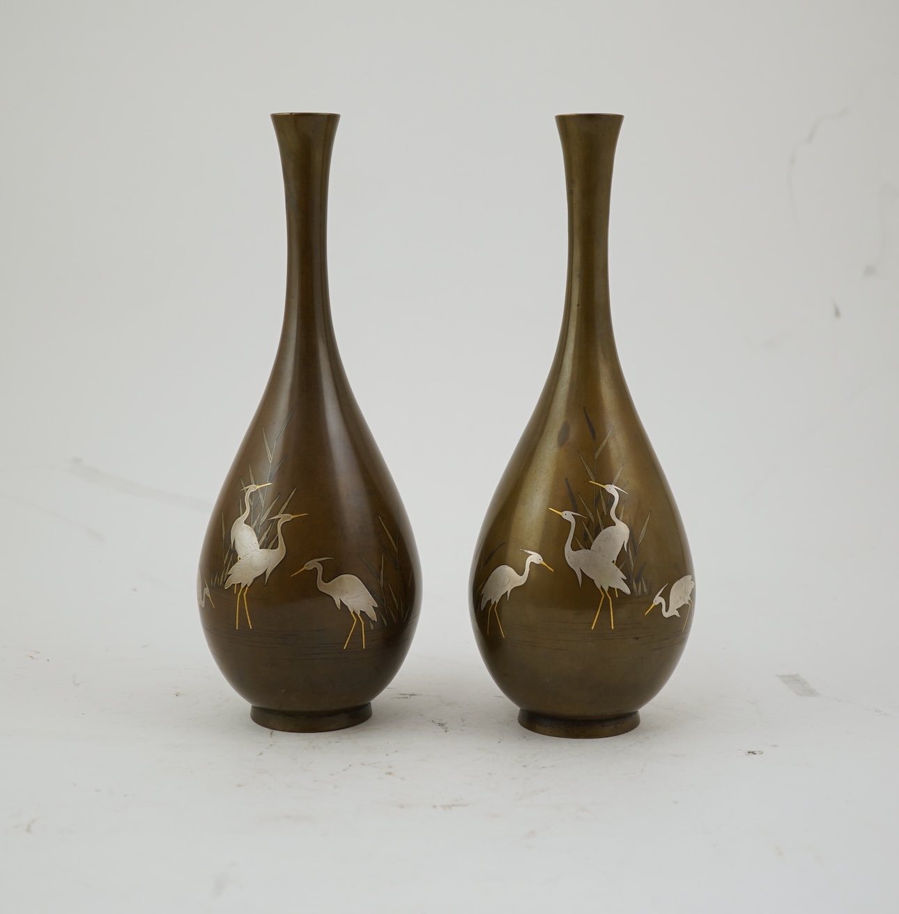 A pair of Japanese bronze and mixed metal inlaid bottle vases, signed Hidemitsu, Meiji period